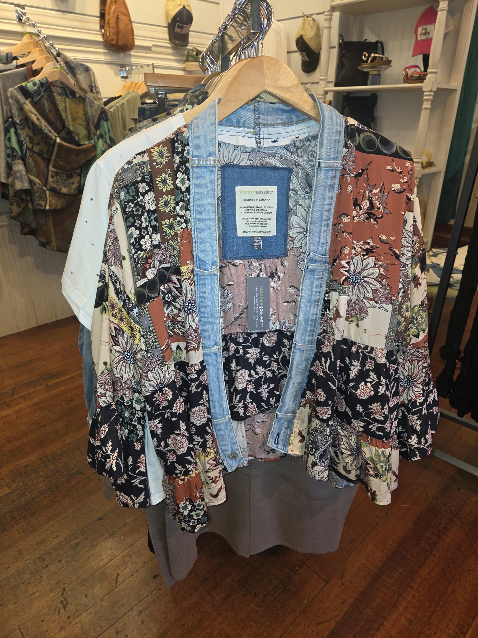 Patchwork floral and denim boutique jacket hanging at Rogue Sole & Style in Grants Pass, Oregon