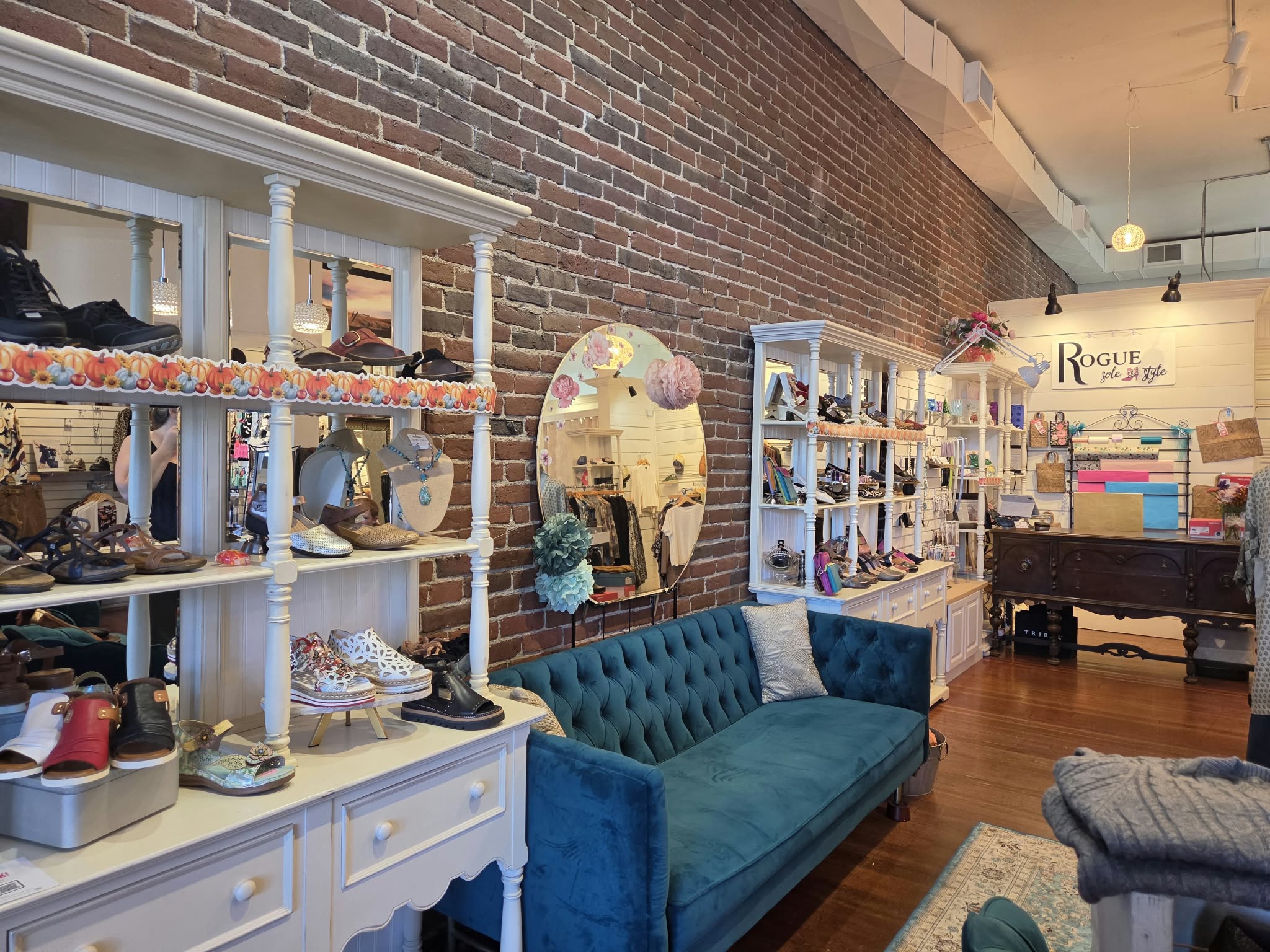 Rogue Sole & Style boutique interior in Grants Pass with shoe displays, jewelry and teal seating
