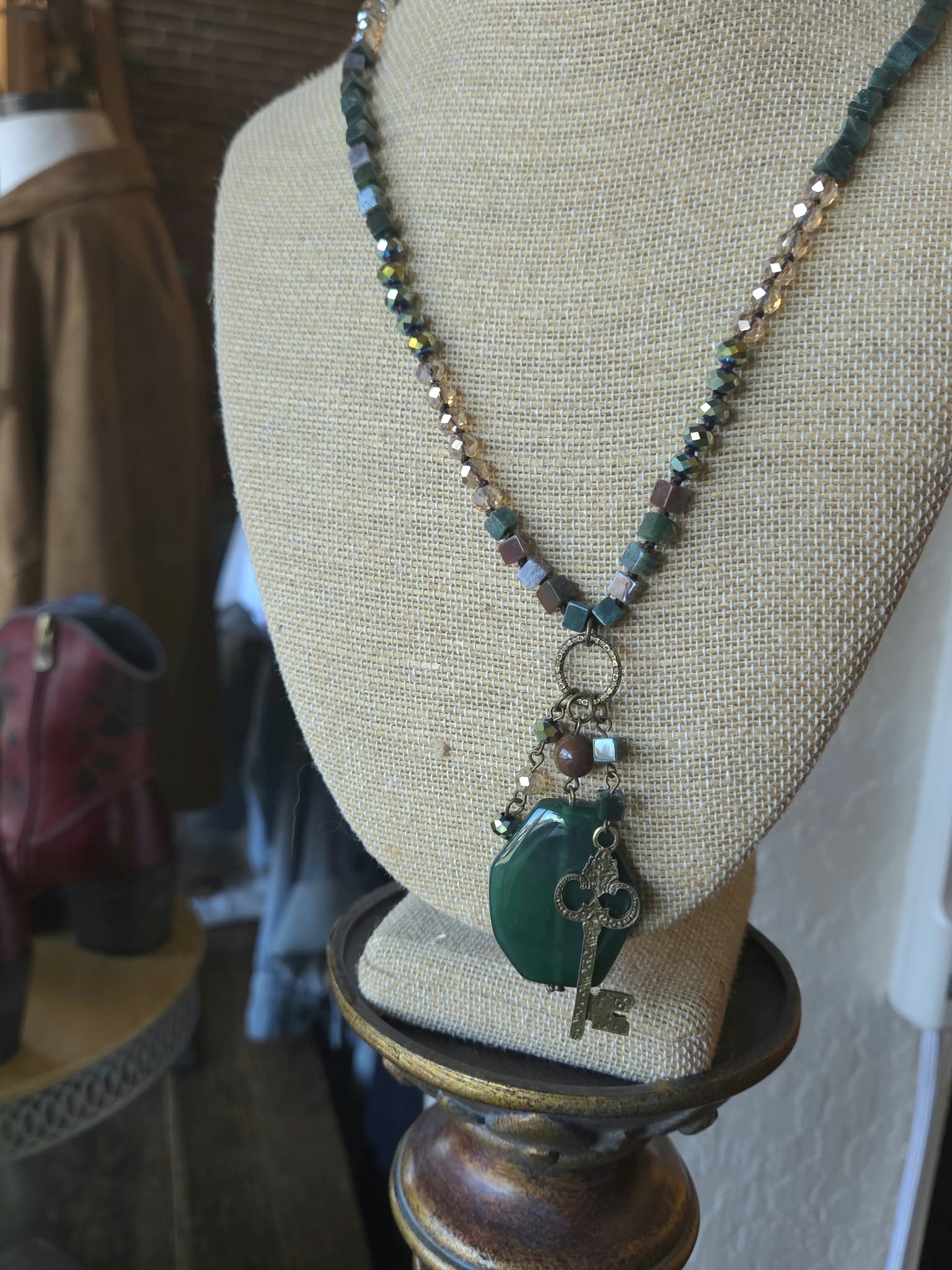 Green stone statement necklace with antique key pendant at Rogue Sole & Style in Grants Pass